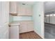 Functional laundry room featuring tiled floors, pastel walls, and ample cabinetry for convenient storage solutions at 6019 Long Peak Dr, Orlando, FL 32810