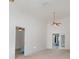 Bright living room with ceiling fan and access to other rooms at 6019 Long Peak Dr, Orlando, FL 32810