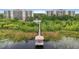 The elevated view showcases two condos connected to a dock and gazebo by a boardwalk through a natural wetland area at 6336 Buford St # 307, Orlando, FL 32835
