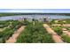 Aerial view of the property featuring beautiful buildings surrounded by lush trees and a lake at 6336 Buford St # 307, Orlando, FL 32835