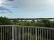 A balcony with a water view is surrounded by trees at 6336 Buford St # 307, Orlando, FL 32835