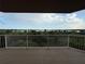 Enjoy the water view from this spacious balcony with white railings at 6336 Buford St # 307, Orlando, FL 32835