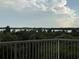 Water view from the balcony with a decorative white railing at 6336 Buford St # 307, Orlando, FL 32835