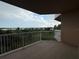 Spacious balcony with white railings, offering a serene outdoor living space overlooking the lush landscape and water at 6336 Buford St # 307, Orlando, FL 32835