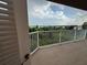 Enjoy the balcony view with white railings overlooking lush greenery and water at 6336 Buford St # 307, Orlando, FL 32835
