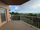 Enjoy a relaxing balcony view with white railings overlooking lush greenery and water at 6336 Buford St # 307, Orlando, FL 32835