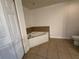 Bright bathroom with a soaking tub and toilet with tile floors at 6336 Buford St # 307, Orlando, FL 32835
