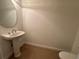 A half bathroom offers a pedestal sink and tile flooring at 6336 Buford St # 307, Orlando, FL 32835