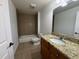 Bathroom with granite countertops, tile shower and white fixtures offers great amenities at 6336 Buford St # 307, Orlando, FL 32835