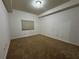 A simple bedroom features neutral carpet and a small window for natural light at 6336 Buford St # 307, Orlando, FL 32835