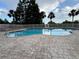 The inviting community pool offers ample space for swimming and relaxation, complemented by well-maintained brick patio and landscaping at 6336 Buford St # 307, Orlando, FL 32835