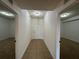 Hallway leading to bedroom and front door shows clean tile floors and white walls at 6336 Buford St # 307, Orlando, FL 32835