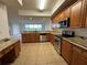 Modern kitchen with stainless steel appliances and granite countertops, adjacent to a living space at 6336 Buford St # 307, Orlando, FL 32835
