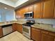 Well-equipped kitchen with stainless steel appliances and stylish granite countertops at 6336 Buford St # 307, Orlando, FL 32835