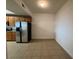 A kitchen nook is visible in this kitchen with tile flooring and stainless steel refrigerator at 6336 Buford St # 307, Orlando, FL 32835