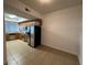 Eat-in kitchen featuring modern stainless appliances, tiled floors and ample counter space at 6336 Buford St # 307, Orlando, FL 32835