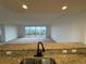 Granite countertop in kitchen with view into living area and windows overlooking outside at 6336 Buford St # 307, Orlando, FL 32835