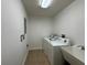 Laundry room with utility sink and machines offers great space and function at 6336 Buford St # 307, Orlando, FL 32835