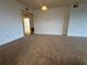 Cozy living area with plush carpeting and neutral paint, creating a warm ambiance at 6336 Buford St # 307, Orlando, FL 32835
