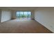 Bright living space with sliding glass doors leading to a balcony, offering serene views at 6336 Buford St # 307, Orlando, FL 32835