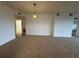 Inviting living area featuring carpet, neutral walls, and a simple light fixture at 6336 Buford St # 307, Orlando, FL 32835
