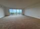 Spacious living room with large windows offering abundant natural light and scenic views at 6336 Buford St # 307, Orlando, FL 32835