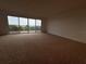 Open living room with carpet and oversized picture window lets in natural light and great view at 6336 Buford St # 307, Orlando, FL 32835