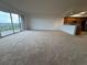 Spacious living area with a large window and balcony access, adjacent to a well-equipped kitchen at 6336 Buford St # 307, Orlando, FL 32835