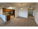 Open-concept living space with a view of a modern kitchen, and a tiled hallway, creating an inviting atmosphere at 6336 Buford St # 307, Orlando, FL 32835