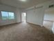 Spacious main bedroom with neutral carpet, window, and balcony access at 6336 Buford St # 307, Orlando, FL 32835