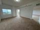 Spacious main bedroom with neutral carpet, window, and balcony access at 6336 Buford St # 307, Orlando, FL 32835