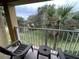 Balcony featuring outdoor seating and views of tropical palm trees, offering a peaceful retreat at 6403 Parc Corniche Dr # 4308, Orlando, FL 32821