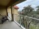 Balcony view with outdoor seating overlooking landscaped grounds and mature trees at 6403 Parc Corniche Dr # 4308, Orlando, FL 32821