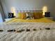 Beautiful bedroom features bright yellow bedding, decorative pillows, and comfortable stylish accents at 6403 Parc Corniche Dr # 4308, Orlando, FL 32821