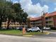 Exterior view of the condo building with balconies, parking lot, and well maintained landscaping at 6403 Parc Corniche Dr # 4308, Orlando, FL 32821