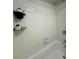 Clean, white tiled shower with corner shelves and modern fixtures at 6403 Parc Corniche Dr # 4308, Orlando, FL 32821