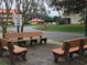 Community shuttle stop with benches, buildings, and manicured landscaping at 6403 Parc Corniche Dr # 4308, Orlando, FL 32821