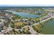 An aerial view shows a Primary-planned community surrounding a lake, with pool and tennis amenities at 6728 Great Bear Dr, Lakeland, FL 33805