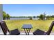 Scenic backyard with view of lake, and wood furniture at 6728 Great Bear Dr, Lakeland, FL 33805