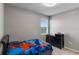 Sunlit bedroom boasts a neutral color palette and is highlighted by a single window at 6728 Great Bear Dr, Lakeland, FL 33805
