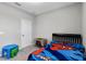 Simple bedroom featuring bright window, carpet floors, and a blue and green table at 6728 Great Bear Dr, Lakeland, FL 33805