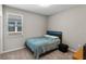 Cozy bedroom with neutral walls, window, plush carpet, and contemporary black bed frame at 6728 Great Bear Dr, Lakeland, FL 33805
