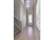Inviting foyer with wood-look tile, and a front door featuring glass panes that let in lots of natural light at 6728 Great Bear Dr, Lakeland, FL 33805