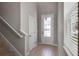 Inviting foyer with wood-look tile, and a front door featuring glass panes that let in lots of natural light at 6728 Great Bear Dr, Lakeland, FL 33805