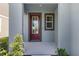 Inviting home entrance with a red front door and lovely landscaping details at 6728 Great Bear Dr, Lakeland, FL 33805