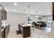 Modern open kitchen with stainless appliances, granite countertops, a large island, and a dining/living room combination at 6728 Great Bear Dr, Lakeland, FL 33805