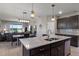 Open kitchen and dining area showcasing granite countertops, a central island, and dark wood cabinetry at 6728 Great Bear Dr, Lakeland, FL 33805