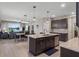 Modern open kitchen with stainless appliances, granite countertops, and a large island overlooking the Gathering room at 6728 Great Bear Dr, Lakeland, FL 33805
