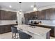Modern open kitchen with stainless appliances, granite countertops, and stylish dark wood cabinetry at 6728 Great Bear Dr, Lakeland, FL 33805