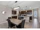 Eat-in kitchen features stainless steel appliances, dark cabinetry, a kitchen island, and stone countertops at 6728 Great Bear Dr, Lakeland, FL 33805